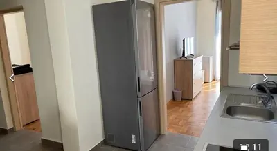 a kitchen with a refrigerator next to a sink at Athens in Athens