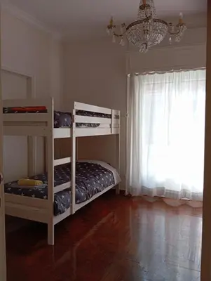 a bedroom with two bunk beds and a chandelier at Dormitory Bunk bed 5' from metro in Athens