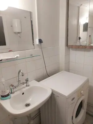 a white bathroom with a sink and a mirror at Dormitory Bunk bed 5' from metro in Athens