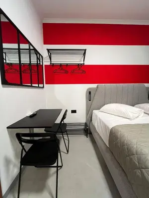 a bedroom with a bed and a desk with a bedskirts at Medusa suite stadiou by Zeussuites in Athens