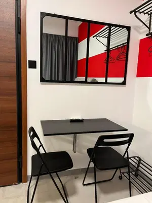 a table and two chairs in a room with a mirror at Medusa suite stadiou by Zeussuites in Athens