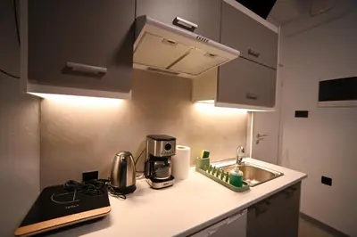 a kitchen with a sink and a coffee maker on a counter at Medusa suite stadiou by Zeussuites in Athens
