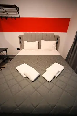 a bedroom with a bed with two white towels on it at Medusa suite stadiou by Zeussuites in Athens
