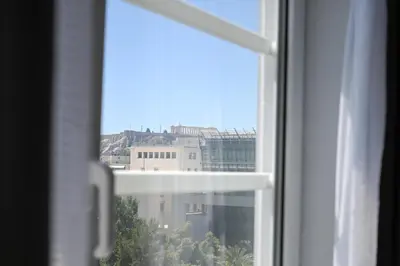a view of a city from a window at Acropolis View Suite Klathmonos by Zeussuites in Athens