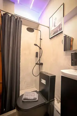 a bathroom with a shower with a toilet and a sink at Acropolis View Suite Klathmonos by Zeussuites in Athens