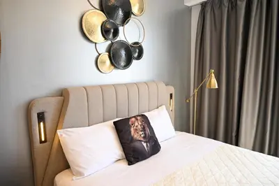 a picture of a man on a pillow on a bed at Acropolis View Suite Klathmonos by Zeussuites in Athens