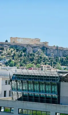 a building on top of a hill with a castle at Acropolis View Suite Klathmonos by Zeussuites in Athens