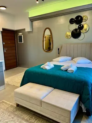 a bedroom with two beds and a mirror at Acropolis Urban Suite Klathmonos by Zeus Suites in Athens