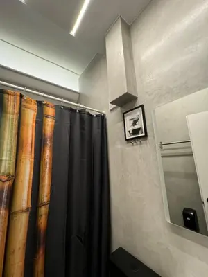 a bathroom with a black shower curtain and a mirror at Acropolis Urban Suite Klathmonos by Zeus Suites in Athens