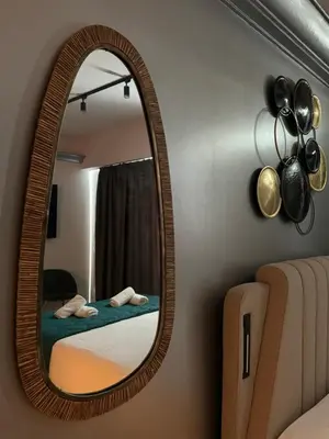 a mirror in a room with a bed and a bed at Acropolis Urban Suite Klathmonos by Zeus Suites in Athens