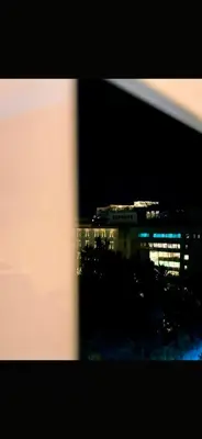 a view of a building at night from a window at Acropolis Urban Suite Klathmonos by Zeus Suites in Athens
