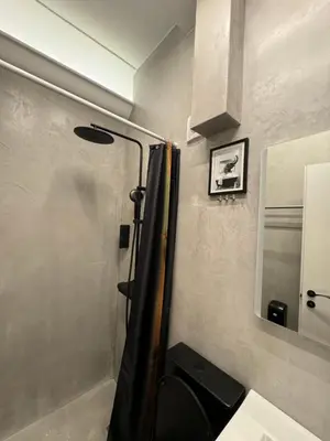 a bathroom with a shower and a sink and a mirror at Acropolis Urban Suite Klathmonos by Zeus Suites in Athens