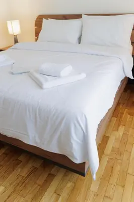 a large white bed with white sheets and pillows at Thea Luxury Rooms Athens in Athens