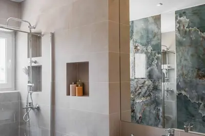 a bathroom with a shower with a glass door at Spacious seaside flat at alimos in Athens