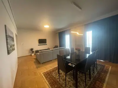 a living room with a table and a couch at Spacious seaside flat at alimos in Athens