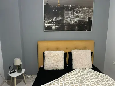 a bedroom with a bed and a picture of a city at Atelier Ioulianou 72 in Athens