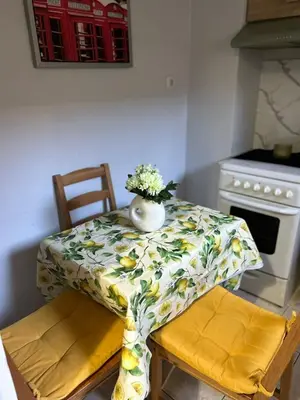 a table with a vase of flowers on top of it at Atelier Ioulianou 72 in Athens