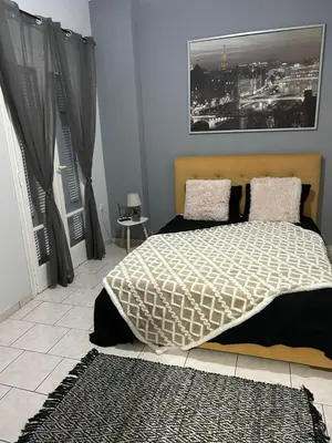 a bedroom with a bed and a picture on the wall at Atelier Ioulianou 72 in Athens