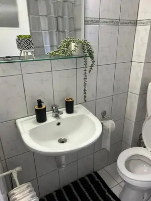 a bathroom with a sink and a toilet at Atelier Ioulianou 72 in Athens