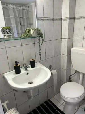 a bathroom with a white sink and a toilet at Atelier Ioulianou 72 in Athens