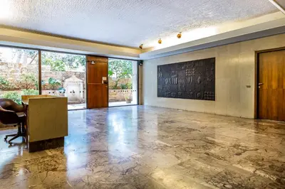 an empty room with a desk and a large window at Comfort Kolonaki Stay - Piano & Art in Athens