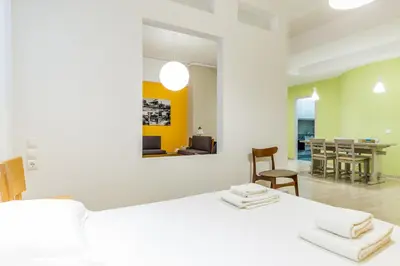 a room with a bed and a dining room at Comfort Kolonaki Stay - Piano & Art in Athens