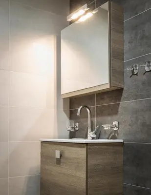 a bathroom with a sink and a mirror at Comfort Kolonaki Stay - Piano & Art in Athens