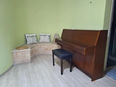 a living room with a piano and a bench at Comfort Kolonaki Stay - Piano & Art in Athens