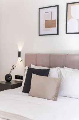 a bedroom with a white bed with pillows and a lamp at Adorable 2BR Apartment in Neos Kosmos by UPSTREET in Athens