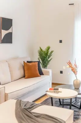 a living room with a couch and a table at Adorable 2BR Apartment in Neos Kosmos by UPSTREET in Athens