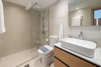 a bathroom with a toilet and a sink and a shower at Niki Athens Suites - Sunny Suite at Historical Centre Monastiraki in Athens