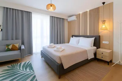 a hotel room with a bed and a chair at Niki Athens Suites - Sunny Suite at Historical Centre Monastiraki in Athens