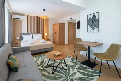 a living room with a couch and a table at Niki Athens Suites - Sunny Suite at Historical Centre Monastiraki in Athens