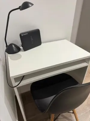 a white desk with a black lamp and a chair at Angel Home in Athens