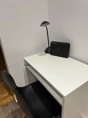 a desk with a black lamp sitting on top of it at Angel Home in Athens