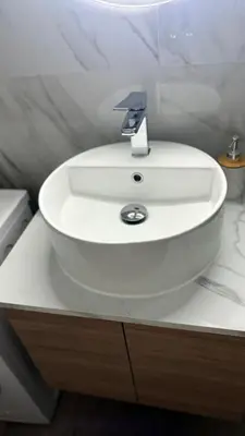 a white sink in a bathroom with a counter at Angel Home in Athens