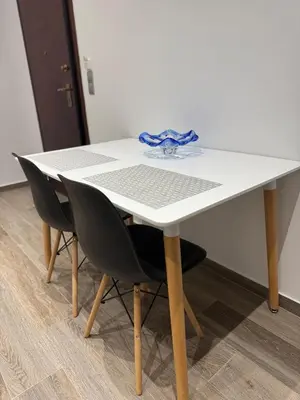 a white table with two chairs and a blue ribbon on it at Angel Home in Athens