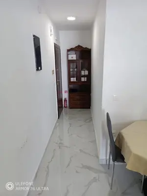 a hallway with a table and a chair in a room at Anis Apartments 2 in Athens