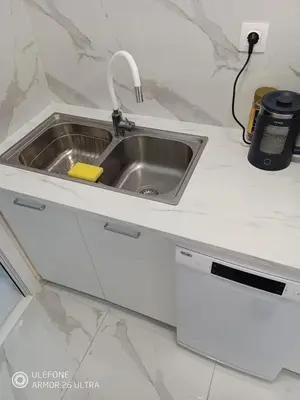 a kitchen sink in a white counter top at Anis Apartments 2 in Athens