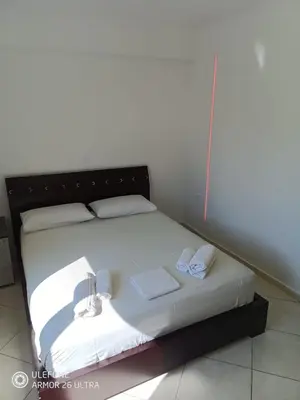 a bed in a room with two towels on it at Anis Apartments 2 in Athens
