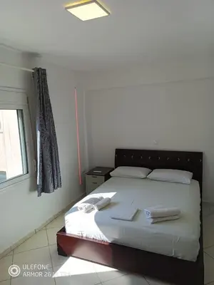 a bedroom with a bed with two towels on it at Anis Apartments 2 in Athens