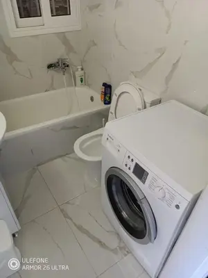 a washing machine in a bathroom with a toilet at Anis Apartments 2 in Athens