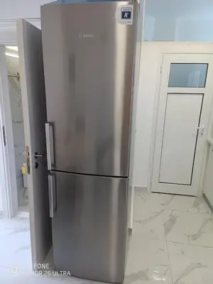 a stainless steel refrigerator in a room with a door at Anis Apartments 2 in Athens