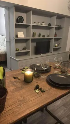 a table with wine glasses and a candle on it at Hidden Gem in the Heart of City in Athens