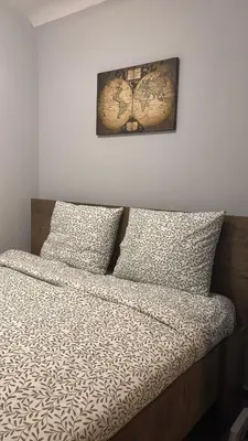 a bedroom with a bed with a picture on the wall at Hidden Gem in the Heart of City in Athens