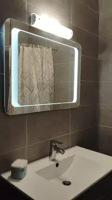 a bathroom with a white sink and a mirror at Hidden Gem in the Heart of City in Athens