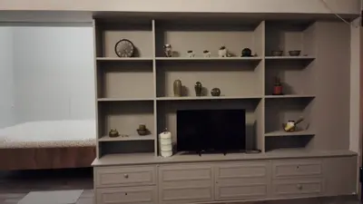 a large entertainment center with a television in a room at Hidden Gem in the Heart of City in Athens