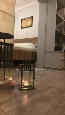 a room with a bed and a table with lights at Hidden Gem in the Heart of City in Athens