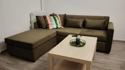 a living room with a couch and a coffee table at Hidden Gem in the Heart of City in Athens