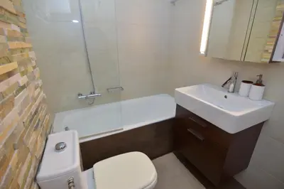 a bathroom with a toilet and a sink and a tub at Vouliagmeni Bay Stylish house with private garden in Athens